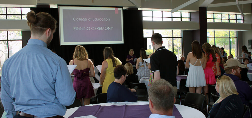 Dr. Chandra Foote, dean of the College of Education, leads the graduating seniors in the recitation of a teacher’s oath during the college's pinning ceremony on May 10, 2024.
