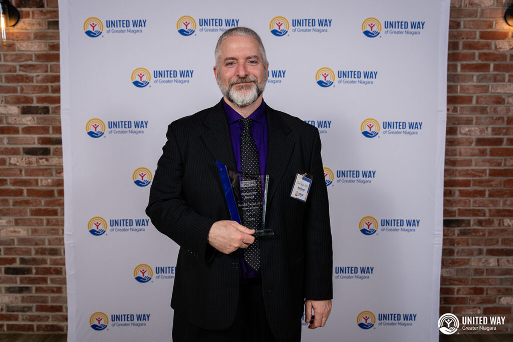 Dave Taylor holding his award
