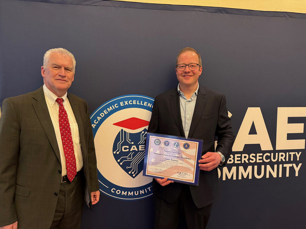 Dr. Timothy Ireland and Dr. Petter Lovaas accept a certificate