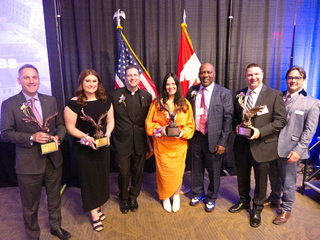 Richard Gold, former M&T Bank president and chief operating officer; Ashley Decker ’19, MBA’20, associate digital marketing manager, integrated performance marketing at Rich Products; the Rev. James J. Maher, C.M., president of Niagara University, Patti and Thurman of the 34 Group; John Ruffolo, ’95, chief financial officer at Horizon Corporations; and Dr. Mark Frascatore, dean of the Holzschuh College of Business Administration.