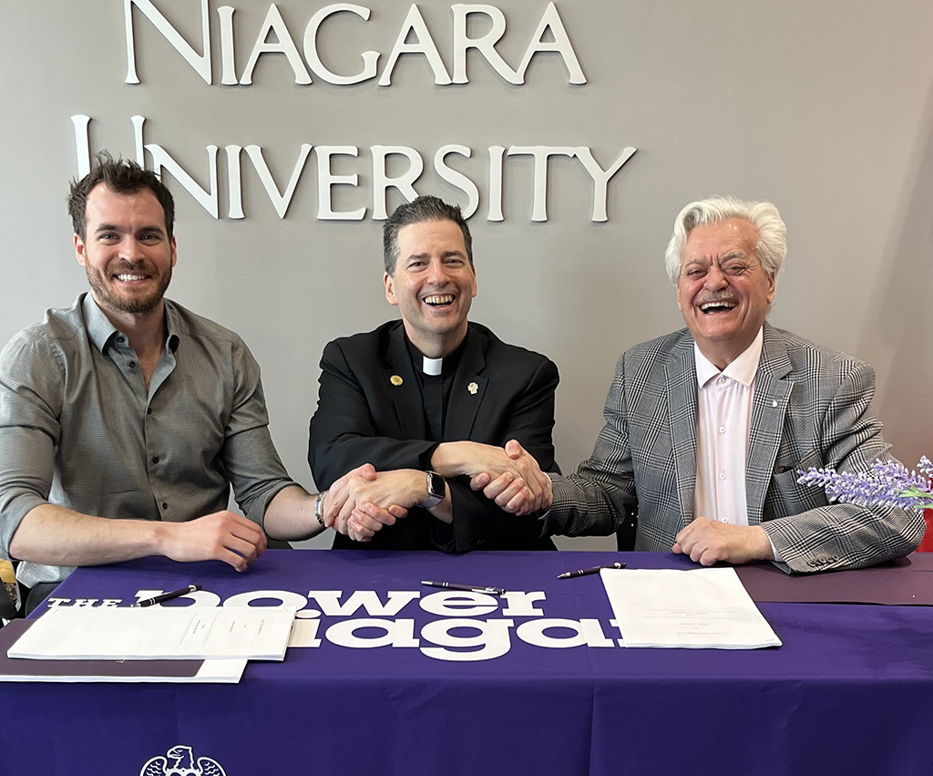 Peter Cortellucci, Rev. James Maher, C.M. and Mario Cortellucci celebrate the signing of the lease.