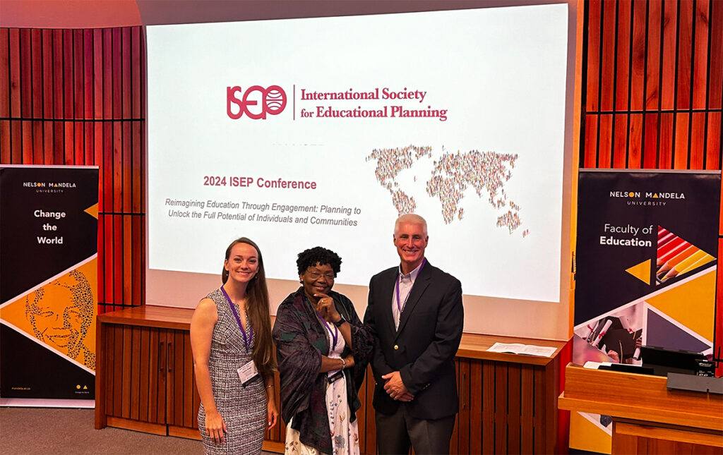 Dr. Caitlin Riegel, Dr. Haoua Hamza, and Dr. John McKenna at the International Society for Educational Planning conference, October 2024.