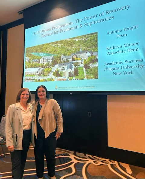 Niagara University Administrators Present at National Symposium on Student Retention Kathryn Marzec and Antonia Knight standing in front of their presentation screen at a national conference.