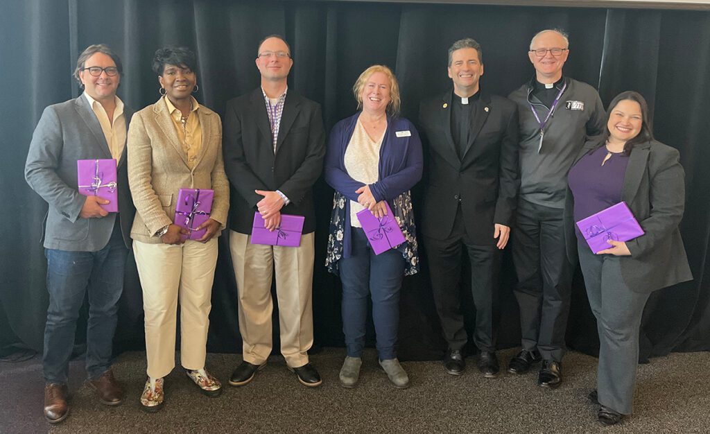 Niagara University’s Vincentian Mission Institute cohort 8 at the VMI Commencement on April 12, 2024. Left to right: Dr. Mark Frascatore; Dr. Tamara Minor; Jeremy Colby; Dr. Carol Doyle-Jones; the Rev. James Maher, C.M., NU president; the Rev. Greg Semeniuk, C.M., NU vice president for mission integration; and Dr. Vennessa Walker.