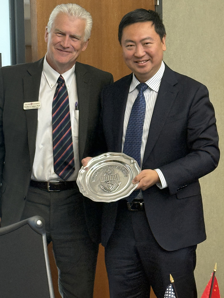 Niagara University Provost Dr. Timothy Ireland gives Consul General Chen Li a pewter plate on behalf of NU President Rev. James Maher, CM