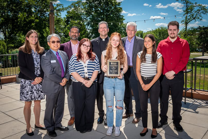 Paige Blatchford holding a plaque