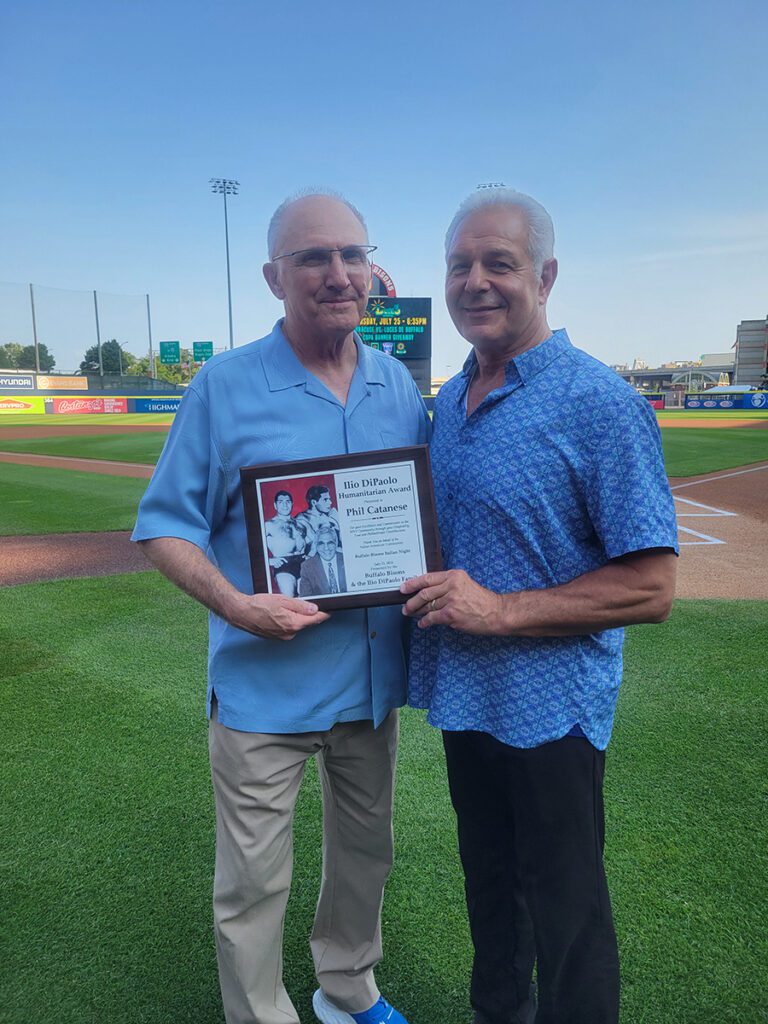 Phillip Catanese (left), director of centers & college outreach at Niagara University, accepts the IlioDiPaolo Humanitarian Award from Dennis DiPaolo.