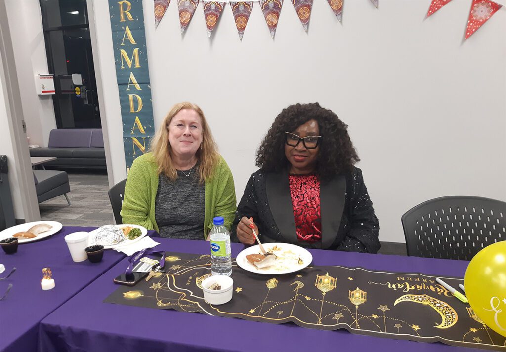 NUO associate professor of education Dr. Carol Doyle-Jones and Dr. Cordelia Yates, a professor in the Sharon Walker School of Education at Morningside University, Iowa, enjoy the traditional foods served during Ramadan at the Iftar hosted by Niagara University in Ontario on March 20, 2024.