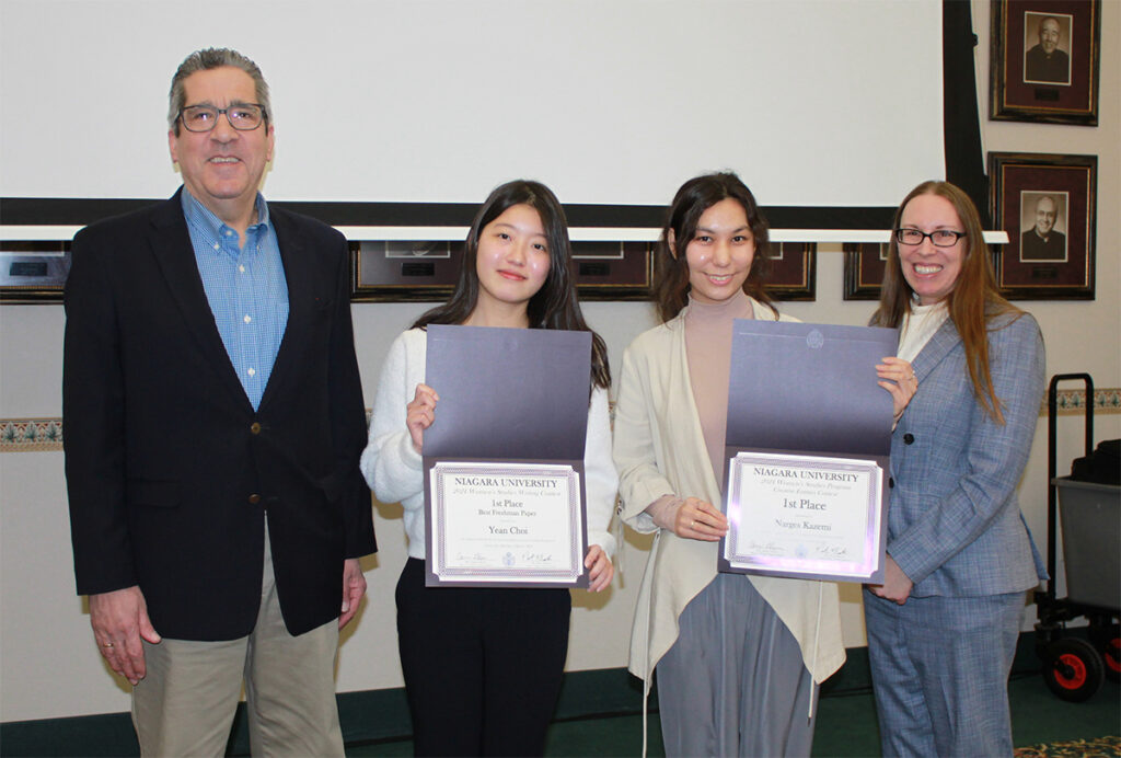 Dr. Peter Butera, dean of the College of Arts and Sciences, and Dr. Carrie Glenn, assistant professor of history and director of the women’s studies program, with research award winners Yean Choi and Narges Kazemi.