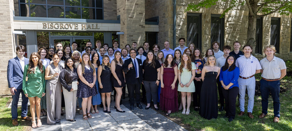 Students standing with Mark Frascatore outside of bisgrove hall