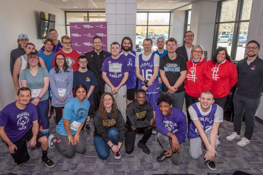 NU's president, the Rev. James J. Maher, Dr. Dennis Garland, Mike Paglicci '16 (Special Olympics), Stan Wojton (NFCSD), Cassie Slaiman '06 & Nicole Granto '03 (NF High School) and Eric Maher (People, Inc.) are joined by coaches and athletes for today's announcement.
