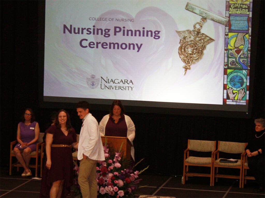 Tucker Trask received his pin from Jennifer Olmstead, director of NU's traditional nursing program, during the College of Nursing's pinning ceremony on May 10, 2024.