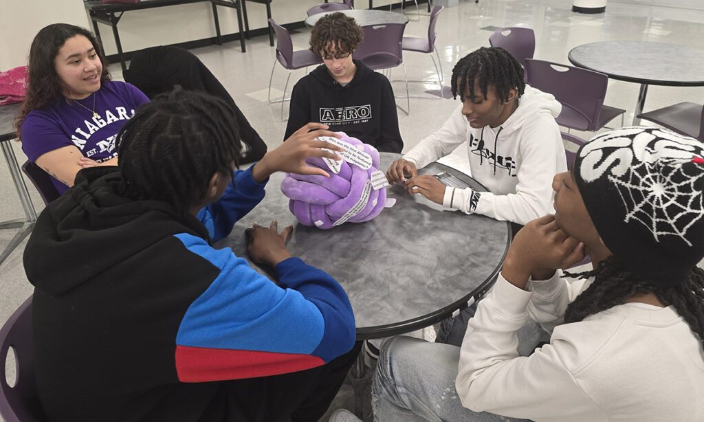 NU freshman Kahlia Portuguese, a Niagara Falls High School graduate and Lois Lyons Brennan Scholarship recipient, talks with Early College/Smart Scholar students.