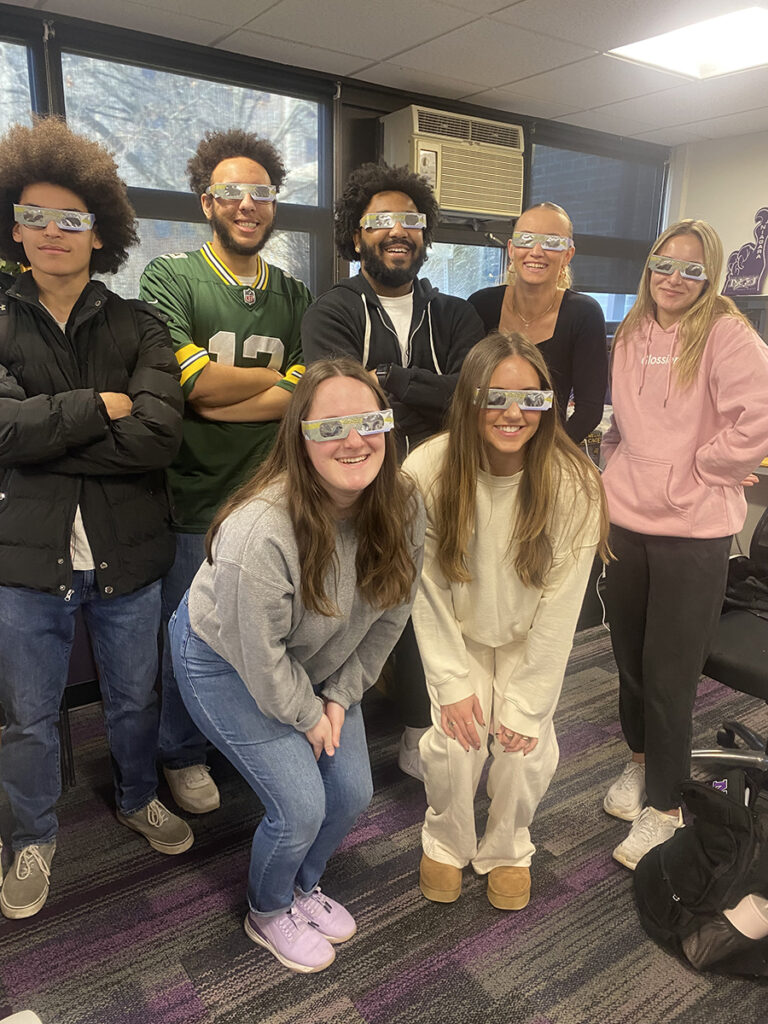 Students in eclipse glasses