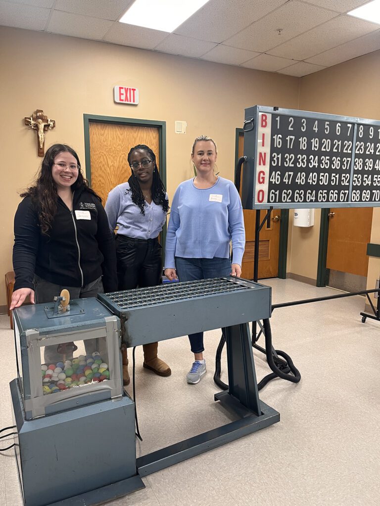 Three students in a BINGO hall.