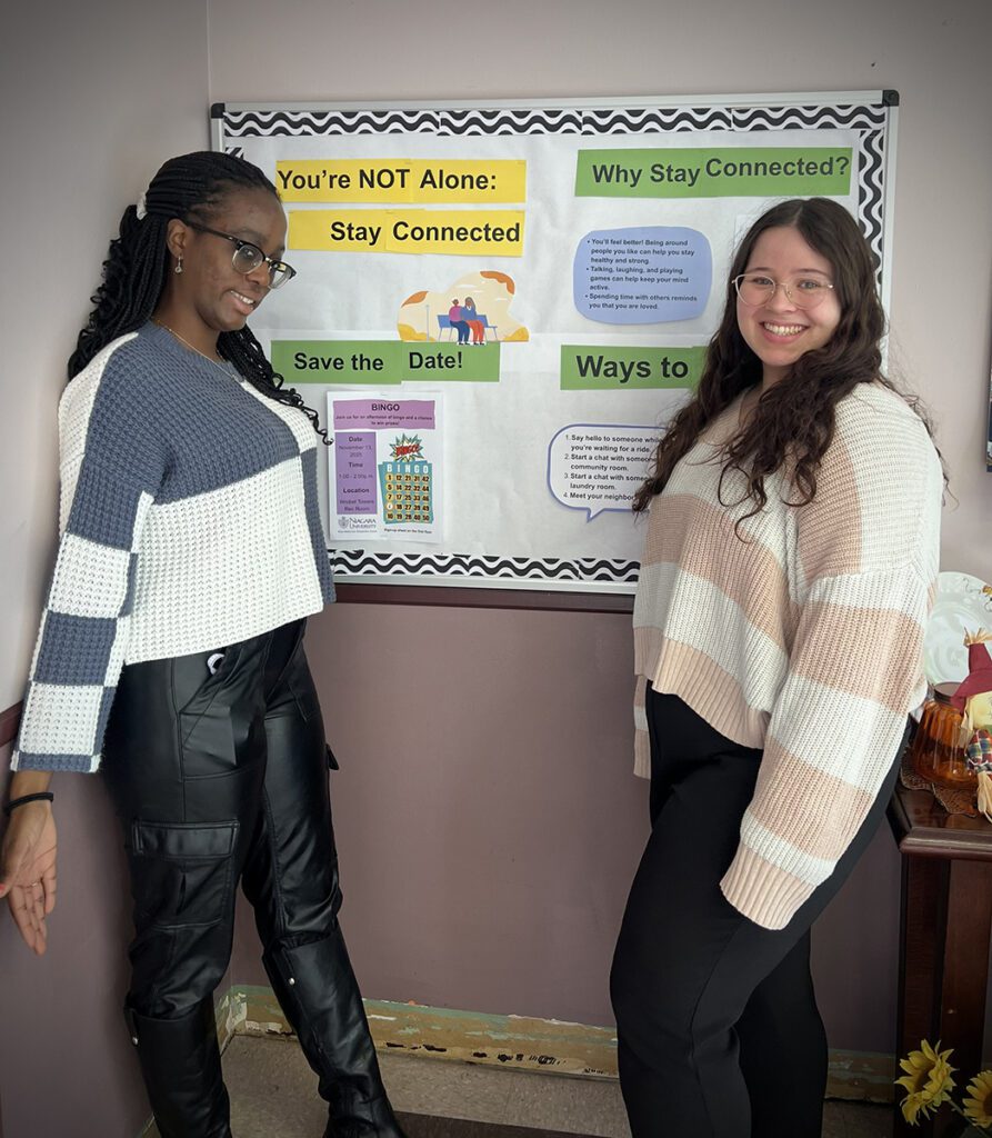Students in front of brightly colored bulletin board
