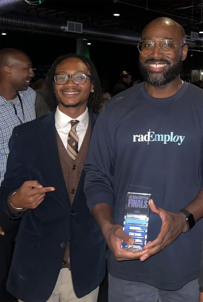 Niagara University student with entrepreneur holding award