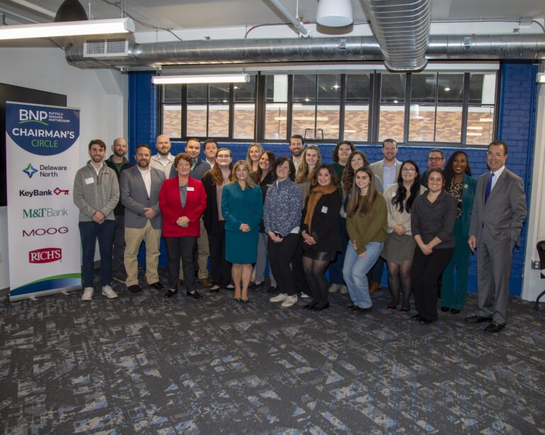 Group of people standing in front of Buffalo Niagara Partnership sign