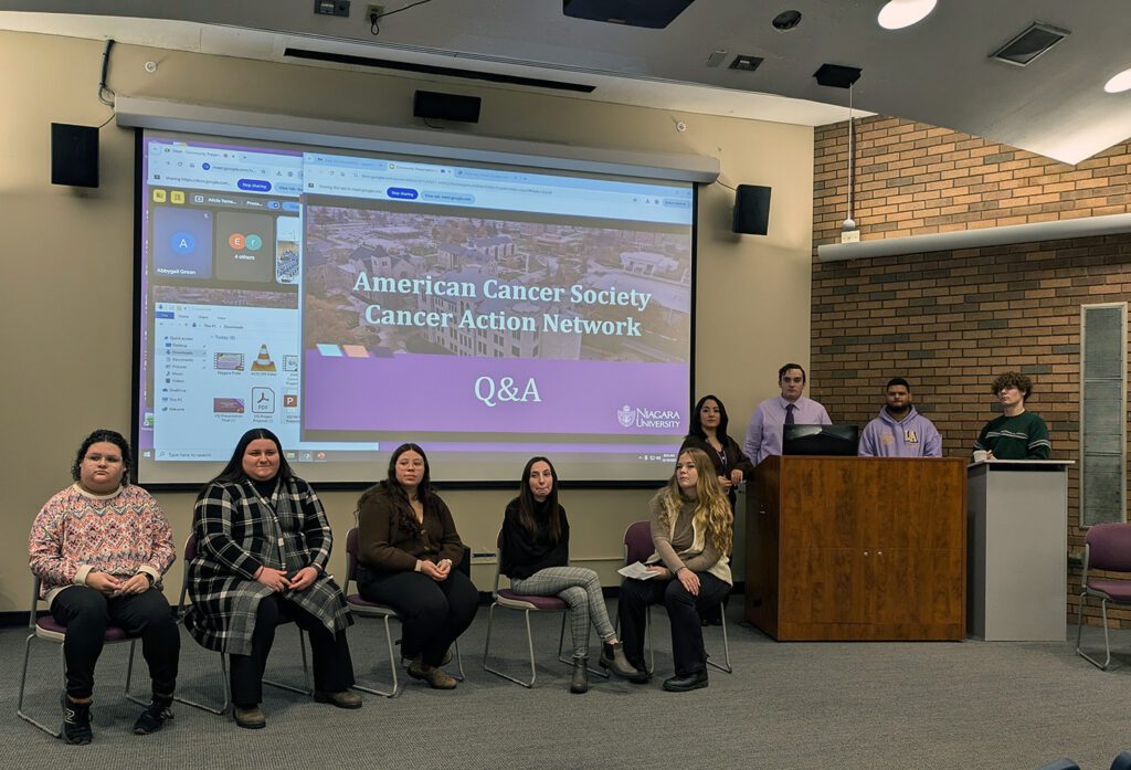 Nine students giving presentation