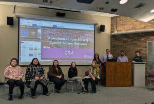 Nine students giving presentation