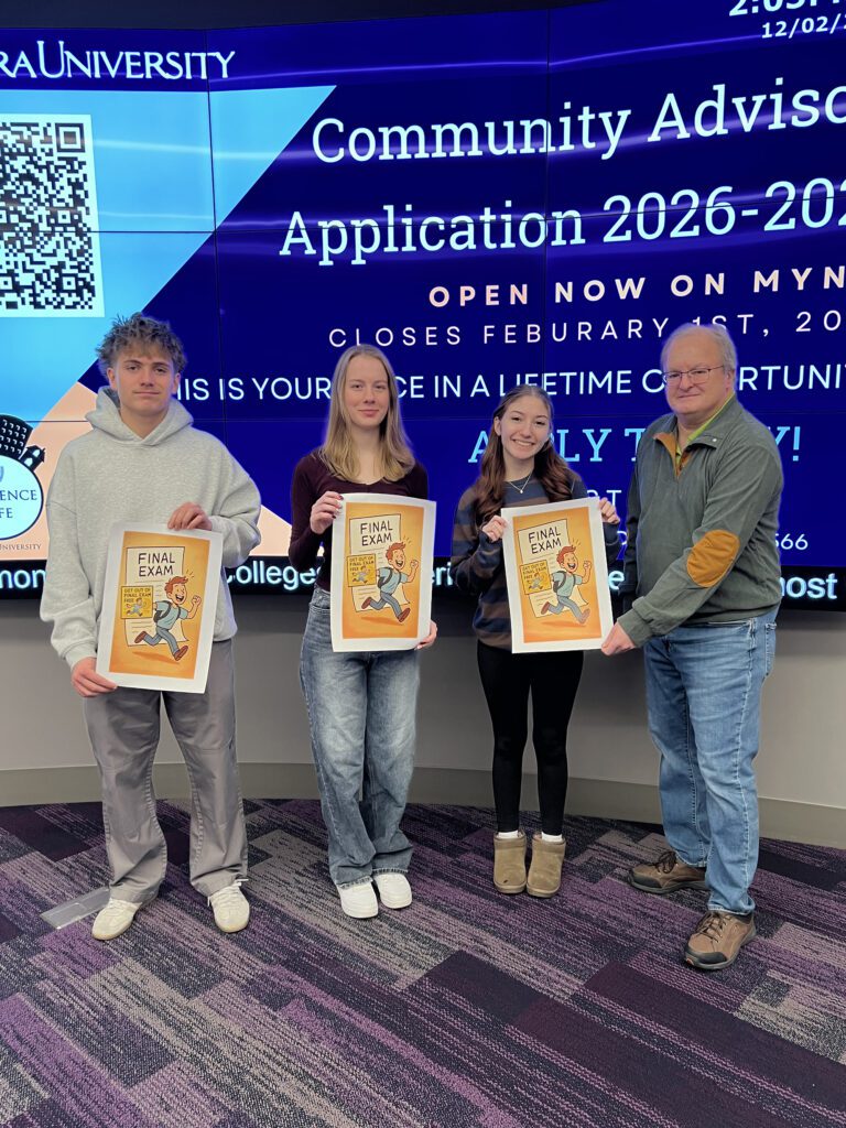 Three college students holding Get Out of the Final Exam Free cards and their professor