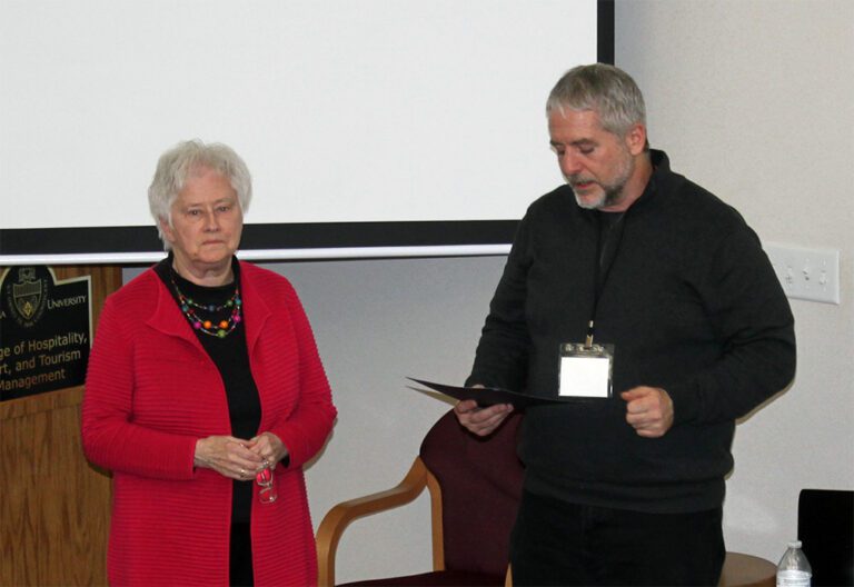Dave Taylor reading award achievements to Sharon Green.
