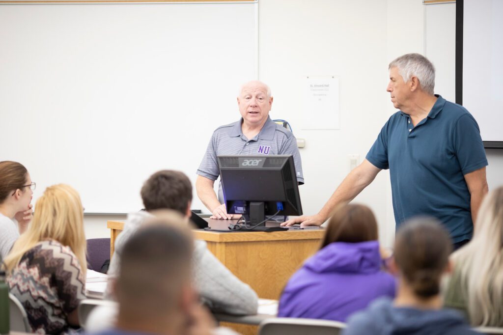 Criminal justice professors speaking during class.