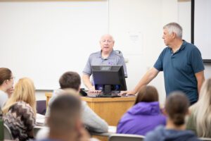 Criminal justice professors speaking during class.