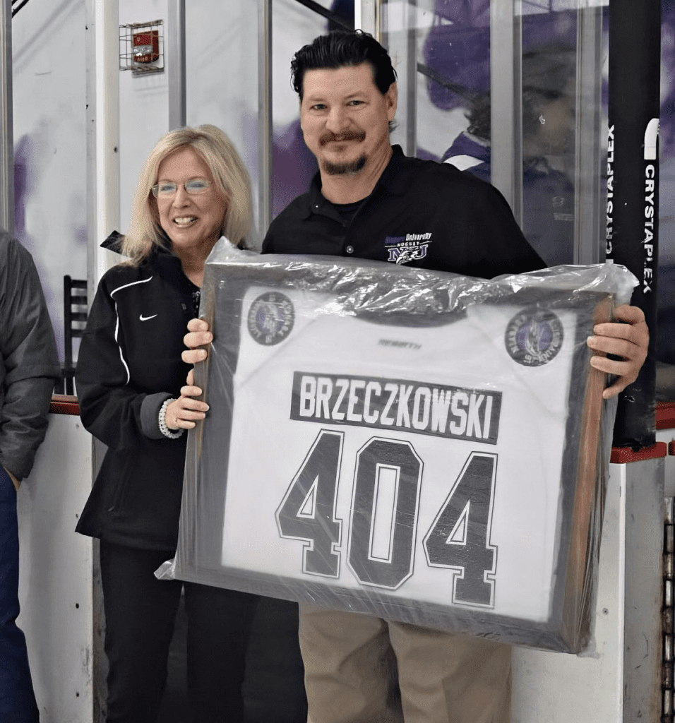 Photo of Larry Brzeczkowski coaching an NU hockey game.
