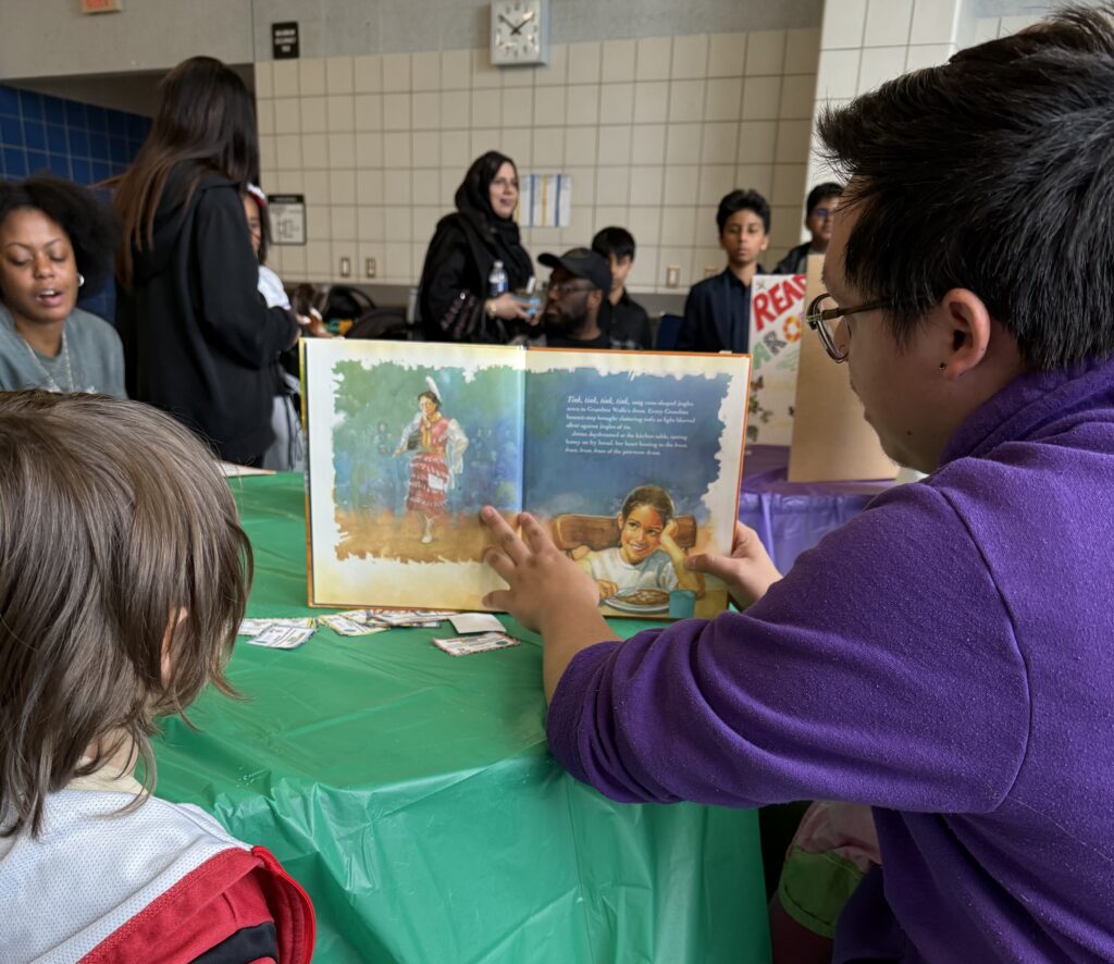A Niagara University student reads a book to a child during the Walk the World Cultural Fair.