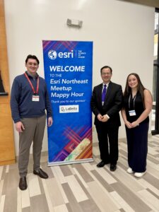 Dr. Yonghong Tong, Mariela Mulready, and Cian Kellet pictured in front of the welcome banner for the event.