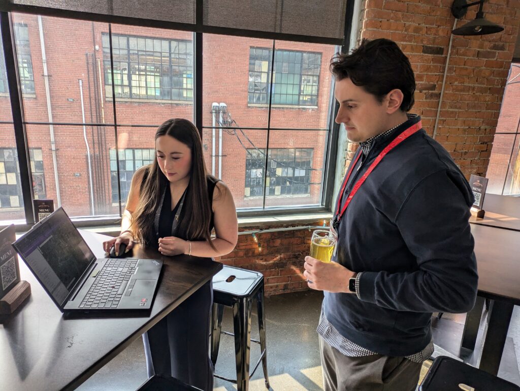 Mariela Mulready and Cian Kellet viewing a laptop together.