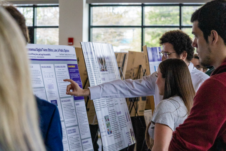 Photo of a poster presentation at the Undergraduate & Graduate Research Conference