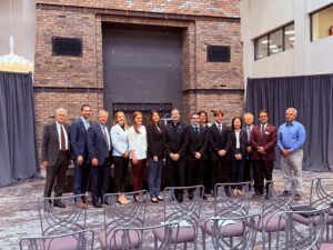 From left, Provost Tim Ireland, Associate Professor Krieg Tidemann, Trustee Thomas Summers, Vice President for Institutional Advancement Jaclyn Rossi Drozd, Associate Digital Integrated & Performance Marketing Manager Ashley Decker, Senior VP of Demand Creation and Revenue Growth Marie-Claude Laprade, President Rev. James J. Maher, C.M., student Brett Verrall, Associate Professor Anna McNab, student Mark Baxter, Associate Professor Lei Han, Professor Chang Huh, Dean Mark Frascatore, and Faculty Fellow Yazbeck Sarkees.
