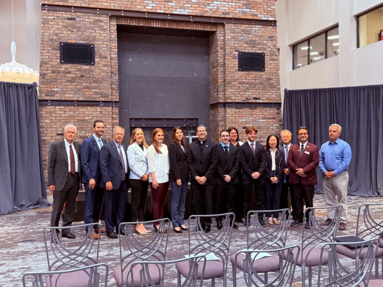 From left, Provost Tim Ireland, Associate Professor Krieg Tidemann, Trustee Thomas Summers, Vice President for Institutional Advancement Jaclyn Rossi Drozd, Associate Digital Integrated & Performance Marketing Manager Ashley Decker, Senior VP of Demand Creation and Revenue Growth Marie-Claude Laprade, President Rev. James J. Maher, C.M., student Brett Verrall, Associate Professor Anna McNab, student Mark Baxter, Associate Professor Lei Han, Professor Chang Huh, Dean Mark Frascatore, and Faculty Fellow Yazbeck Sarkees.