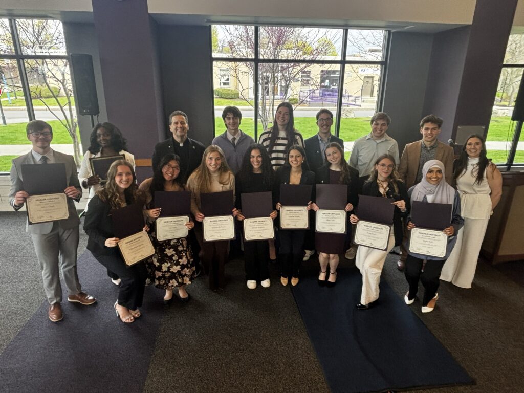 Inductees of the Niagara University President's Honor Society are pictured with the Rev. James J. Maher, C.M., NU president, and keynote speaker Sara Villnave.