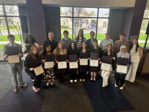 Inductees of the Niagara University President's Honor Society are pictured with the Rev. James J. Maher, C.M., NU president, and keynote speaker Sara Villnave.