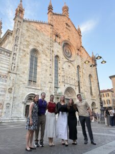 A group photo standing before the stunning, historic architecture of the local cathedral features Dr. Guerinot, Fr. Maher, and the four summer interns.