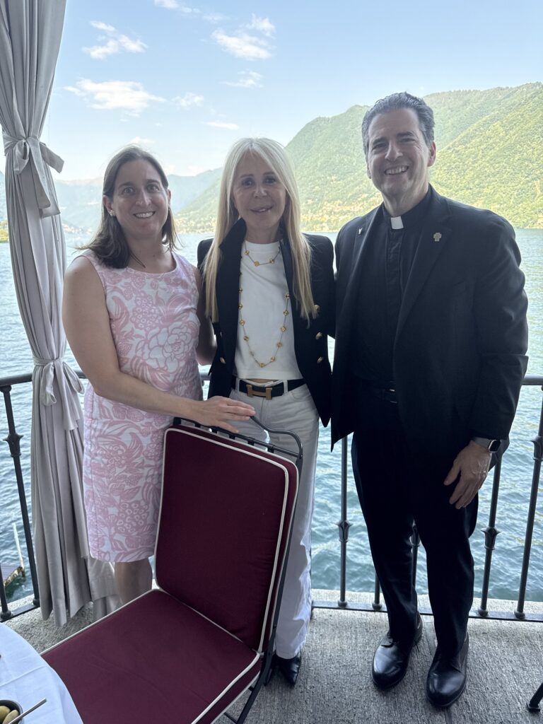 Dr. Guerinot and Fr. Maher are pictured alongside Zucchi against a scenic backdrop of Lake Como and its towering mountains.