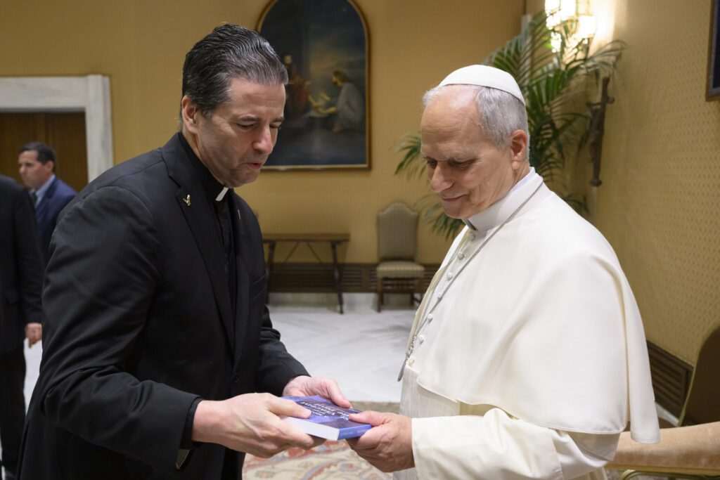 Father Maher presents a book on St. Vincent de Paul to Pope Leo XIV.