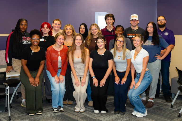 Social Work seniors take group photos after receiving their badges.