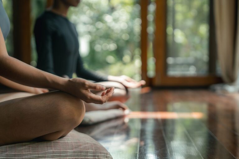 A person sitting cross legged and meditating