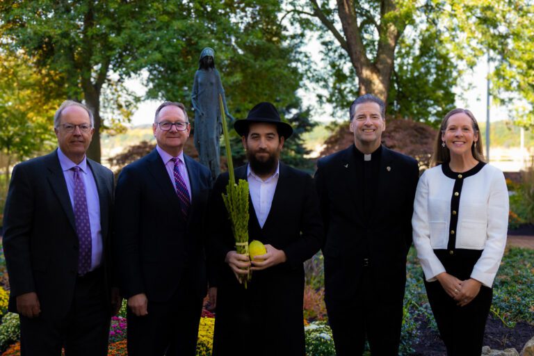 Five people in a group posing for a photo.